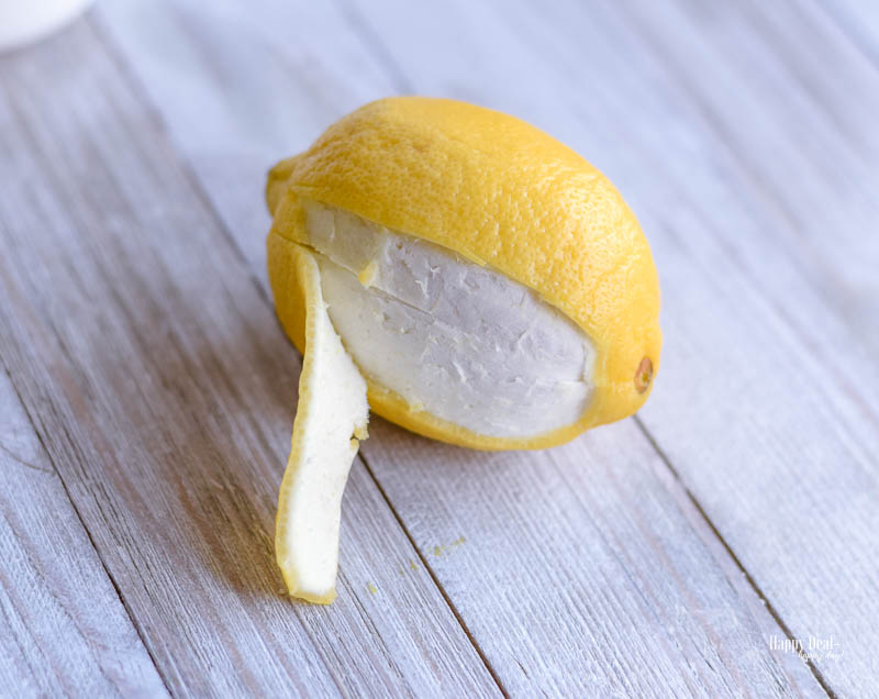 peel of the <span style='background-color:none;'>lemon peel</span><span style='background-color:none;'> </span>to use in lemon infused olive oil recipe” width=”800″ height=”636″ data-pin-description=”This easy DIY homemade lemon infused olive oil is great for cooking, as an ingredient in salad dressing, and can be used as a bread dipping olive oil. #infusedoliveoil #lemoninfused #lemonoliveoil #infusedoliveoilrecipe”></h3>
<h2>How to infuse olive oil with lemon:</h2>
<ol>
<li>Using a vegetable peeler or paring knife, carefully strip one lemon of its zest. Try to keep each strip long and wide, and avoid getting any of the bitter white pith underneath. Stuff the zest strips into your bottle. Set aside.</li>
</ol>
<p><img loading=