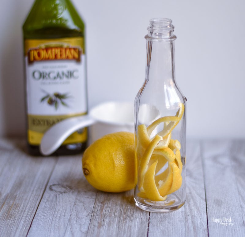 place lemon peels inside bottle of lemon infused olive oil