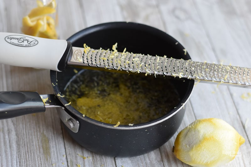 use a grater to get <span style='background-color:none;'>lemon zest</span><span style='background-color:none;'> </span>into simmering hot oil” width=”800″ height=”533″ data-pin-description=”This easy DIY homemade lemon infused olive oil is great for cooking, as an ingredient in salad dressing, and can be used as a bread dipping olive oil. #infusedoliveoil #lemoninfused #lemonoliveoil #infusedoliveoilrecipe”></p>
<p>3. In a saucepan, heat on medium heat until a few small bubbles start forming. If you have a candy-making thermometer, you can measure the temp of the oil, and when it gets to 180 F and then add the lemon zest to the oil while it is heating. (If your oil starts smoking, take it off the stove and allow it to cool for 10 minutes.)</p>
<p>4. When you see bubbles, turn off the heat or turn it to very low heat and let it steep for about 30 minutes. You should be able to smell the bright aroma of the lemon while it heats – it smells delicious!!!</p>
<p><img loading=